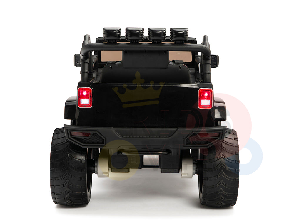 A rear view of the 4X4 Big Wheels EVA Edition 12v Kids and Toddlers Ride on Truck shows its black coloring, large tires, and two red tail lights. It features an upgraded roll bar with additional lights and includes a remote control for extra fun against a white background.