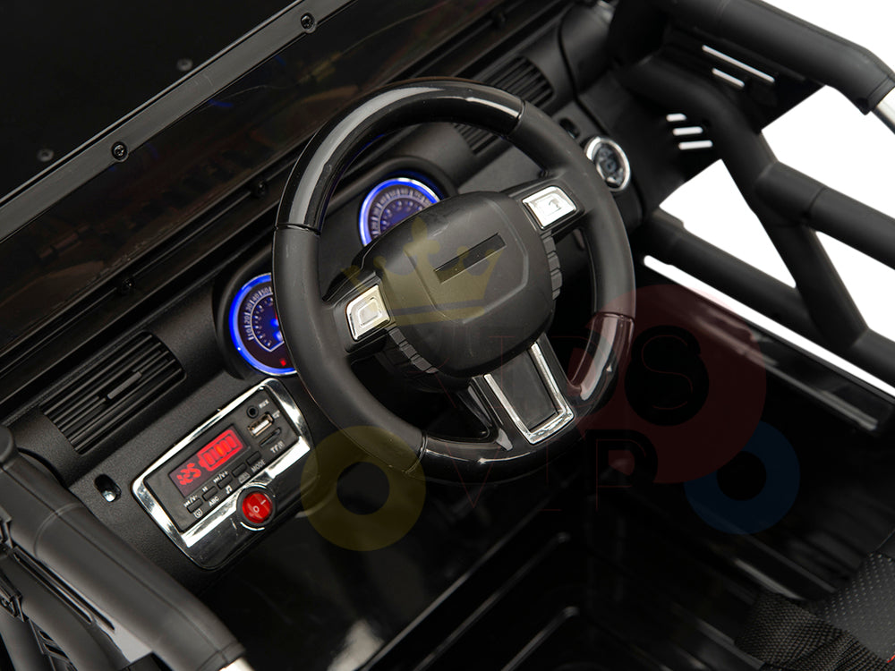 Close-up of the 4X4 Big Wheels EVA Editions dashboard: steering wheel, blue-lit speedometer, and 00:00 digital display. With RC upgrade and a sleek black panel with a red button, it mirrors the sophistication of a 12v ride-on truck.