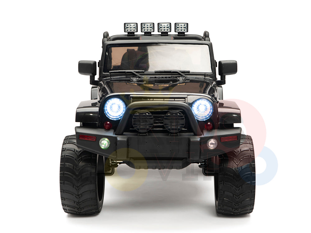 The black 4X4 Big Wheels EVA Edition 12v Ride-on Truck for kids displays a front view with large tires, roof-mounted lights, and glowing headlights. It features realistic details like a front bumper and side mirrors, along with an upgraded remote control, set against a white background.