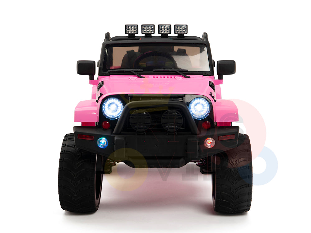 Front view of the pink 4X4 Big Wheels EVA Edition 12V Kids and Toddlers Ride-on Truck with large tires and bright headlights. Features a black grille, roll bar with lights, red and blue side lights, plus parental remote control for peace of mind while your child drives in style.