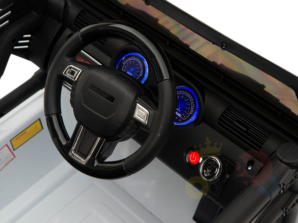 The 4X4 Big Wheels EVA Edition 12v Kids Ride-on Truck features a black interior dashboard with a plastic steering wheel, lit blue speedometer, and ignition start button. Perfect for adventurous play, it includes visible vents and labels on its sides.