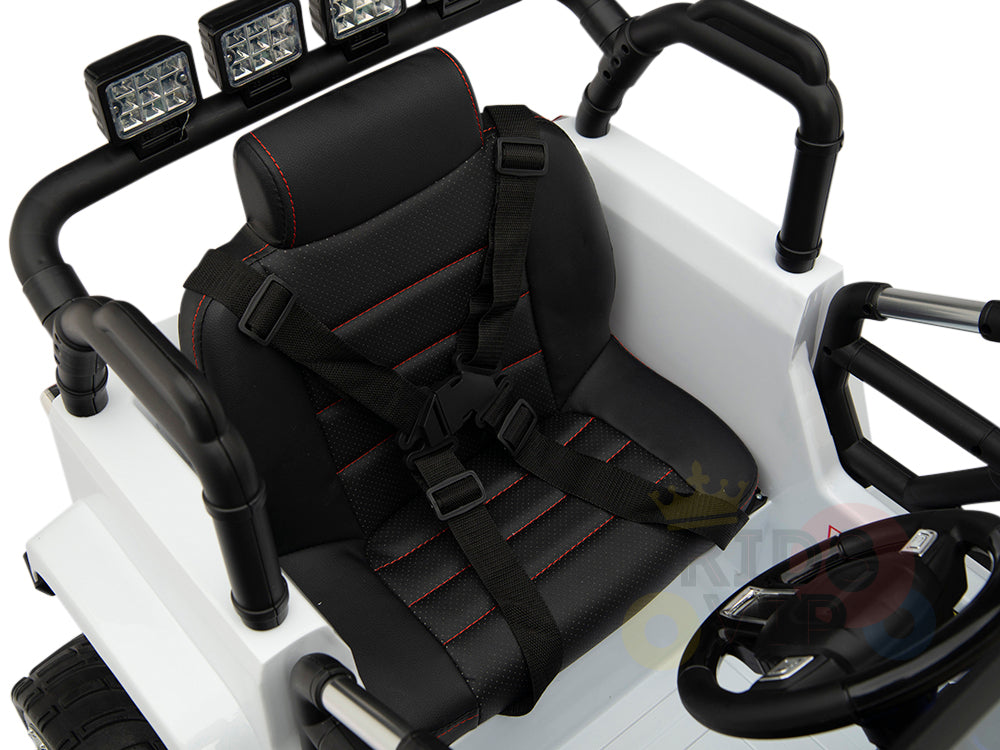 The 4X4 Big Wheels EVA Edition 12v Kids and Toddlers Ride-on Truck offers a sleek white design with a black seat featuring red stitching and a four-point safety harness. It boasts big wheels, a parental remote, black steering wheel, roll bars, and overhead LED lights for added enjoyment.
