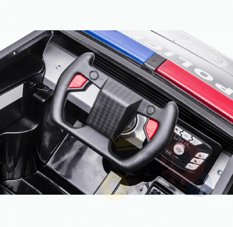 Inside the Futuristic 12V Fire Truck Ride On for kids, a black steering wheel with red buttons is visible. The dashboard includes various controls, and the exterior roof showcases a red-and-blue light bar featuring POLICE.