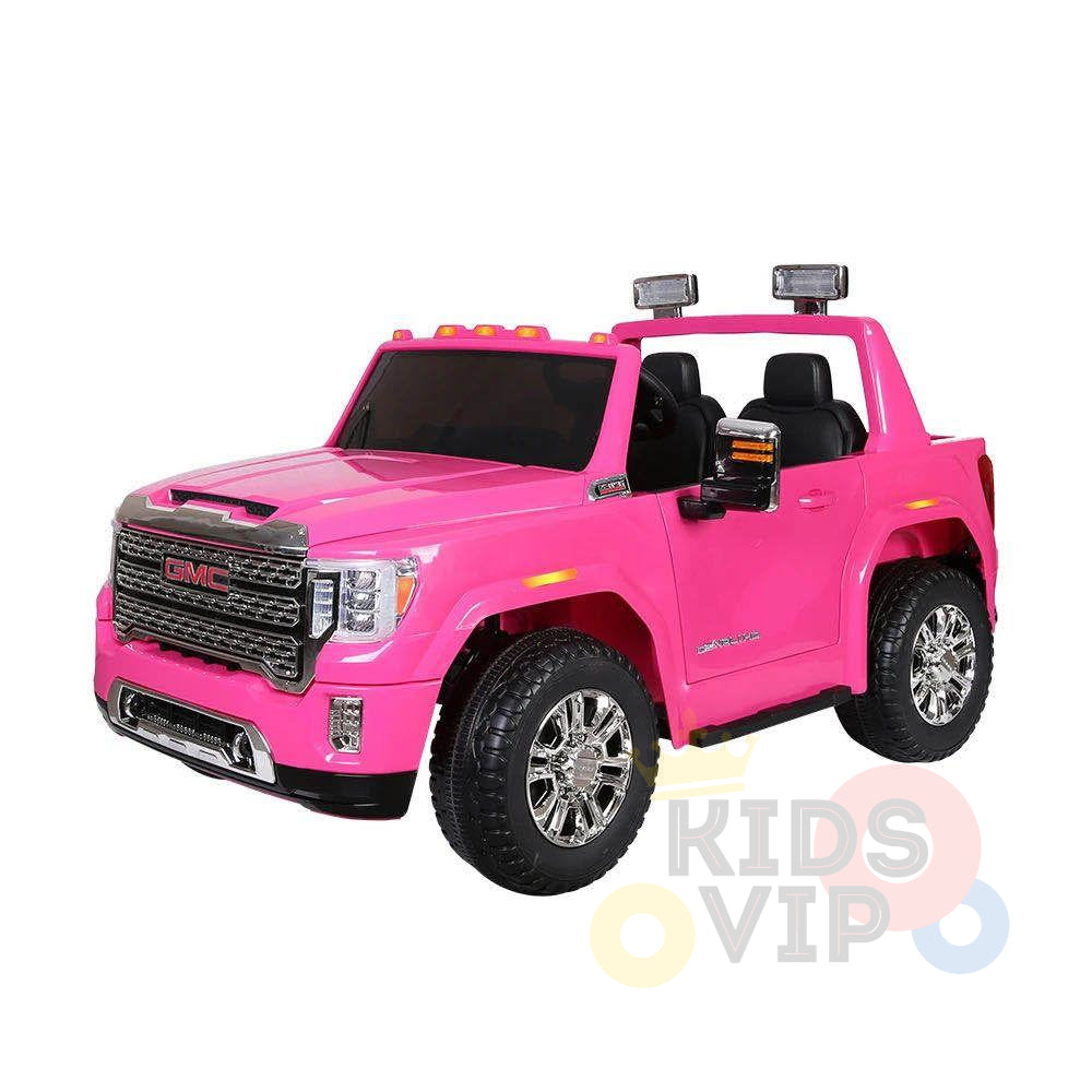 The Pink 2x12V Licensed 4WD GMC Sierra Kids Ride On Car with RC features detailed headlights, a grille, chrome wheels, black seats, rearview mirrors, roof lights, and a partially visible Kids VIP logo in the lower right corner.