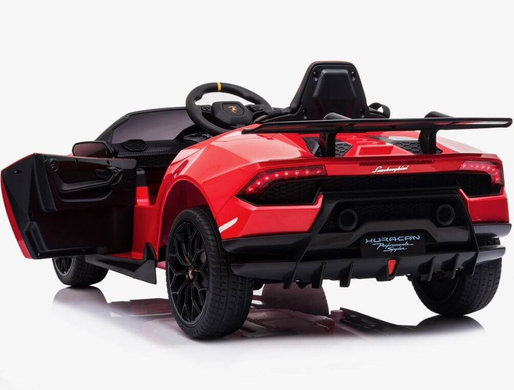 The Officially Licensed 12V Lamborghini Huracan Sports Edition Ride on Car is a vibrant red toy sports car for kids with an open drivers side door, rear spoiler, detailed wheels, branding and decals, and is shown from the rear at a slight angle.
