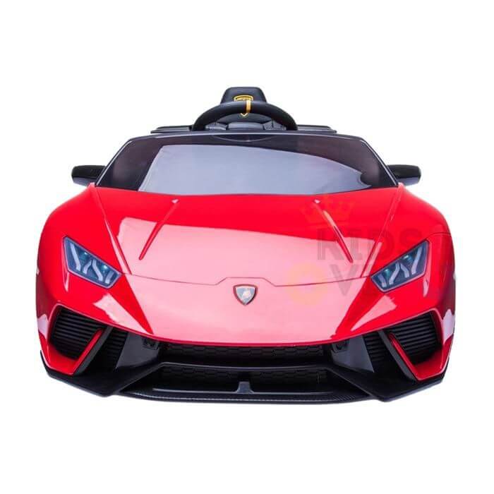The Officially Licensed 12V Lamborghini Huracan Sports Edition Ride-On Car is a sleek red toy with black accents, detailed headlights, a prominent front grille, and a visible steering wheel, designed to mirror the aerodynamic style of a miniature luxury sports car.