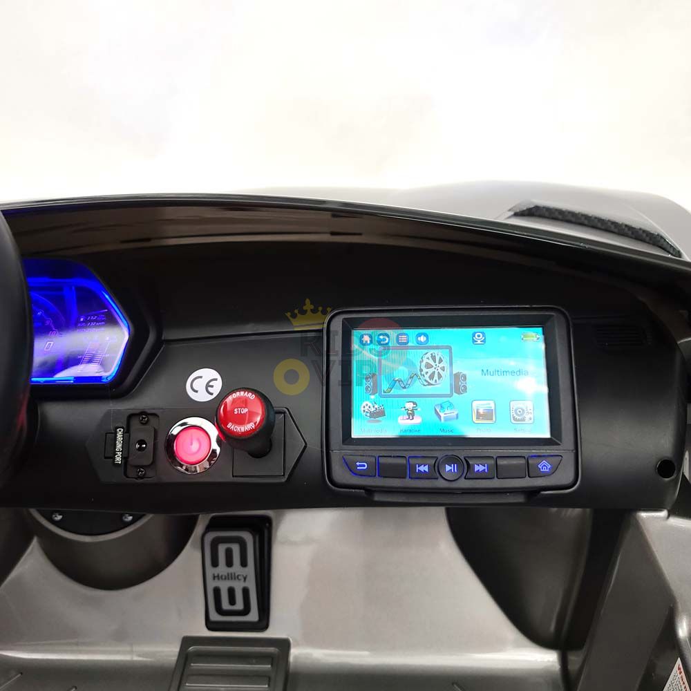 Experience the Ultimate Thrill: Upgrade Your Rides control panel on the 24V Lamborghini Sport Car features a digital touchscreen with icons, red emergency stop button, sleek blue USB port, and illuminated speedometer. The background hints at Handy, foot pedal symbols, and drifting adventures.