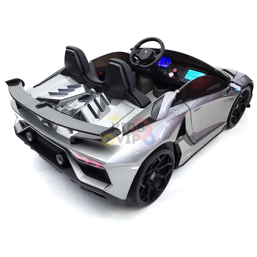 The 24V Lamborghini ride-on sports car features a sleek silver design, detailed interior with black seats and steering wheel, rear spoiler, and black wheels. Enjoy the luxury look with KidsVip Warranty for quality assurance.