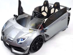 The Complete Edition 24V Lamborghini Sport Car in metallic gray, complete with a sleek design and open left door, features black wheels, dual seats, and a detailed steering wheel for an authentic sports car experience. Drive confidently with the KidsVip warranty.
