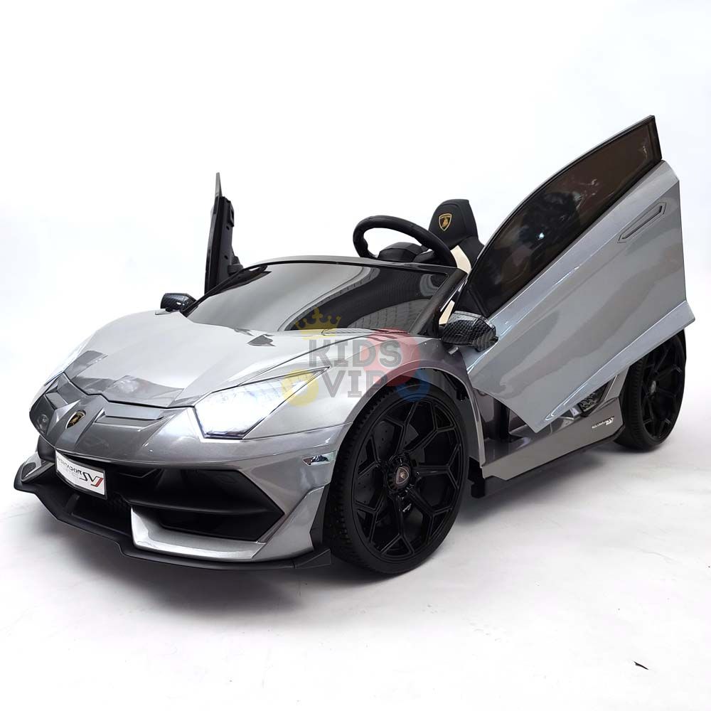 The Upgrade Your Ride: Experience the Thrill of Drifting with the Complete Edition 24V Lamborghini Sport Car is a shiny gray ride-on resembling a real sports car, with open scissor doors, black wheels, and a steering wheel on a white background. Enjoy peace of mind with the KidsVip warranty.