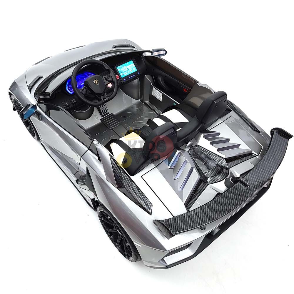 A top-down view of a sleek, metallic silver toy car resembling the Complete Edition 24V Lamborghini Sport Car. With detailed interior features, black accents, and an aerodynamic design, it offers the thrill of drifting for young luxury enthusiasts.
