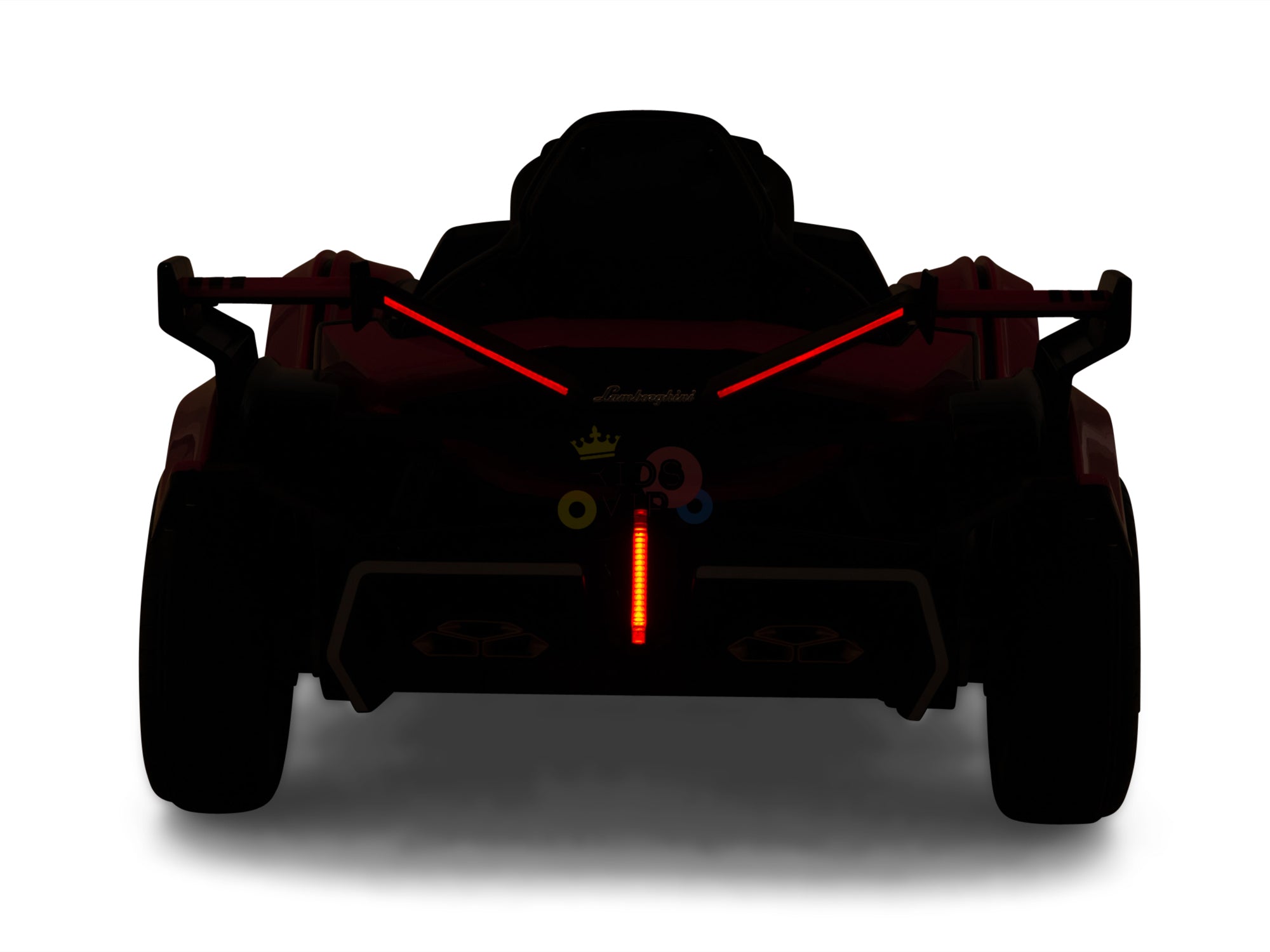 Silhouetted rear view of the Blue Official Complete Edition 12V Lamborghini Vision GT Kids Ride-On Car with illuminated red V-shaped taillights and a central vertical red light, colorful stickers on the back, and an eco-leather seat in a dark setting.