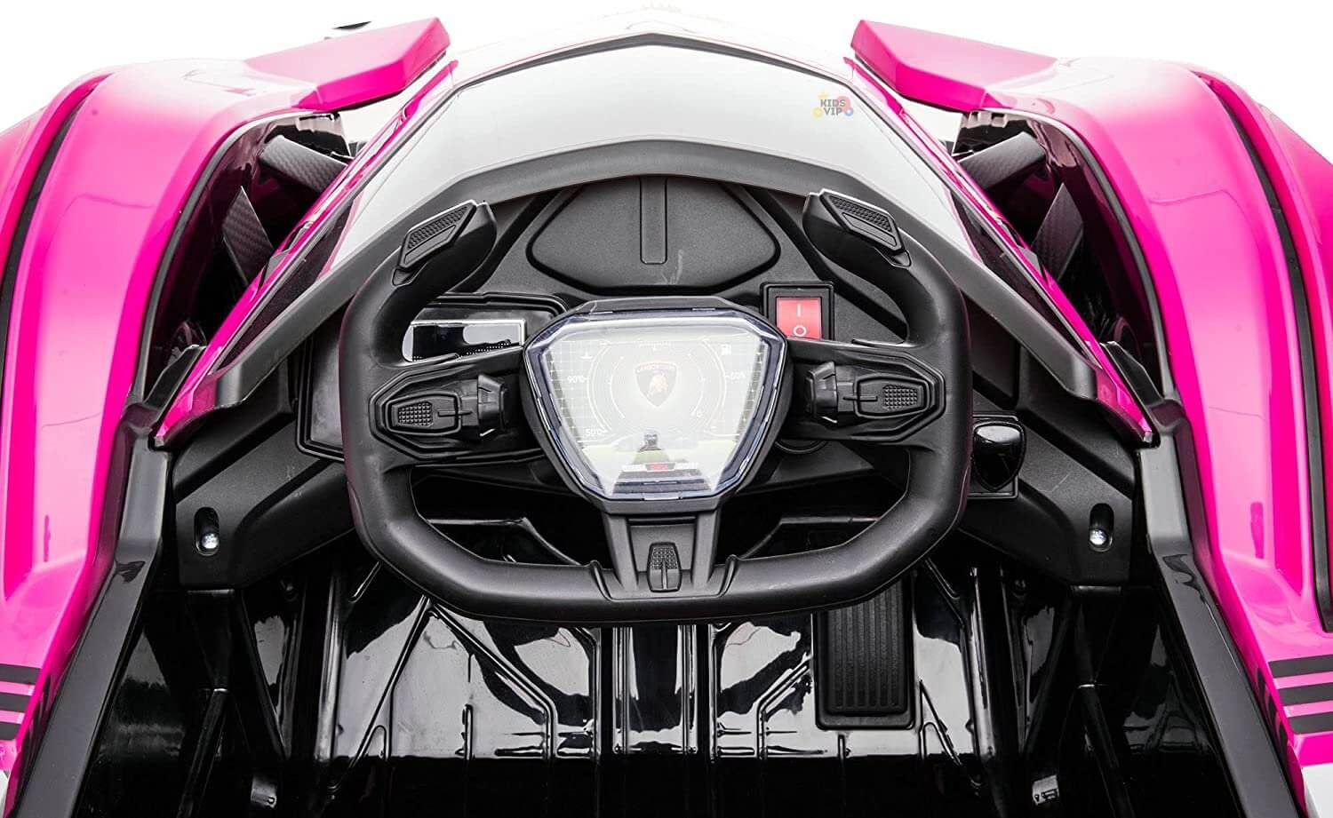 Close-up of a futuristic cockpit in the Pink 12V Official Lamborghini Vision GT Kids Ride-on Car features a central steering wheel, digital display, and sleek controls. The design showcases glossy black with vibrant pink accents for a modern aesthetic.