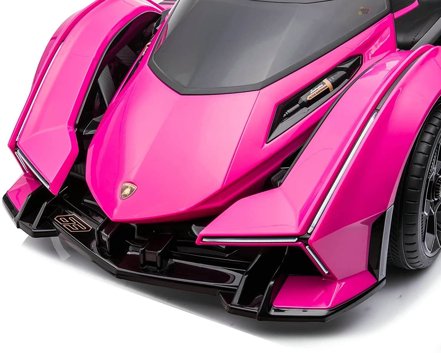 The Pink 12V Official Lamborghini Vision GT Kids Ride-On Car features a sleek, aerodynamic hot pink design with sharp angles and angular headlights. Black accents and a glossy finish enhance its futuristic appeal.