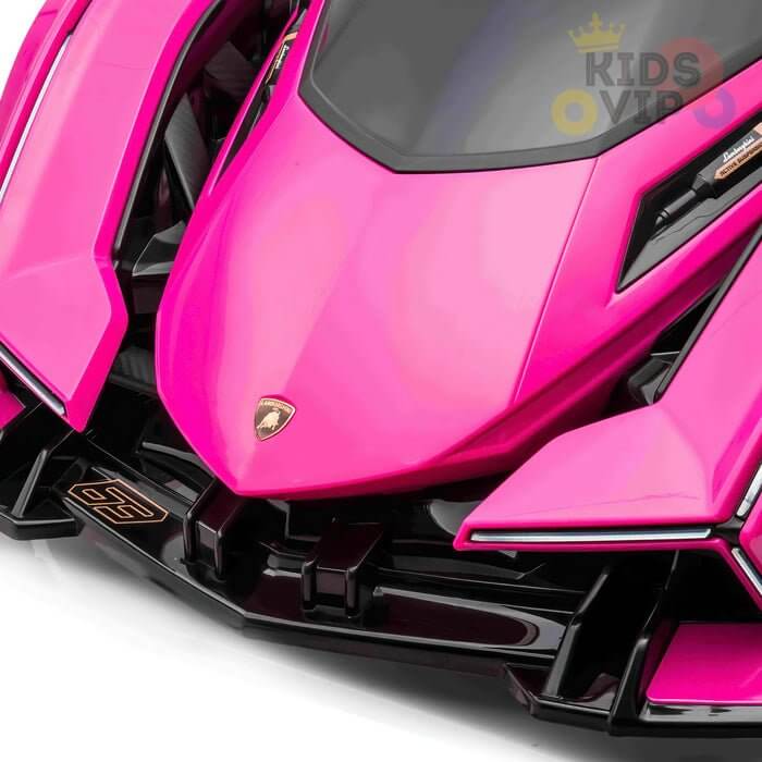 Close-up of the Pink 12V Official Lamborghini Vision GT Kids Ride-On Car, featuring a vibrant pink design with sleek aerodynamic lines and a detailed emblem. The windshield is surrounded by black accents, promising young drivers a thrilling experience.