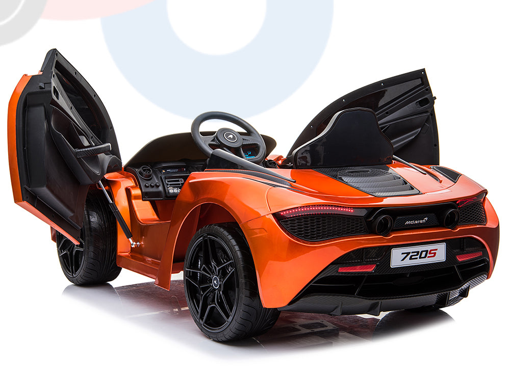 The Orange 12V McLaren 720S Kids Licensed Ride On Car features butterfly doors, a detailed dashboard, and black rubber wheels, echoing the luxury sports car’s sleek design and high-end appeal.