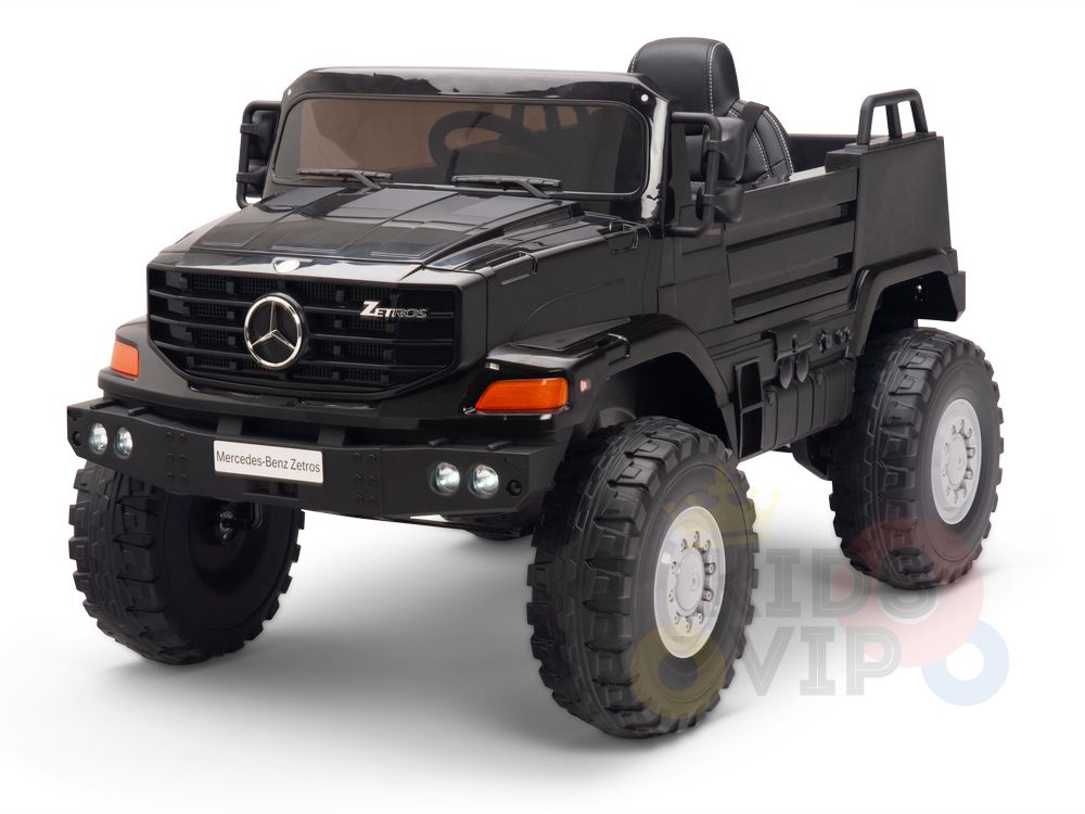 The Black 12V Mercedes Benz Zetros Kids 1 Seater Ride On Truck features an open-back design, rubber off-road wheels, a detailed front grille, and realistic logos for an authentic ride. Powered by a 12V battery, it resembles the real Mercedes-Benz Zetros and includes a remote control.