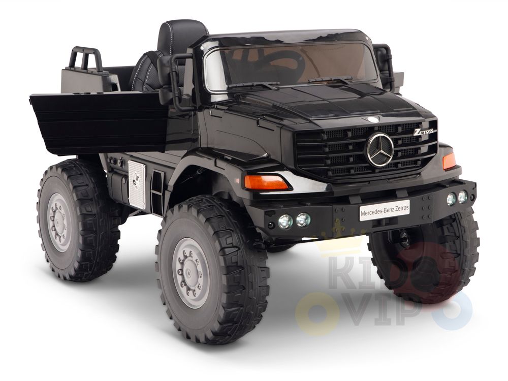 A black 12V Mercedes Benz Zetros Kids 1 Seater Ride On Truck with realistic detailing, including a Mercedes emblem grille, side mirrors, rugged rubber wheels, and an open cabin. Perfect for kids driving adventures and includes a remote control option.