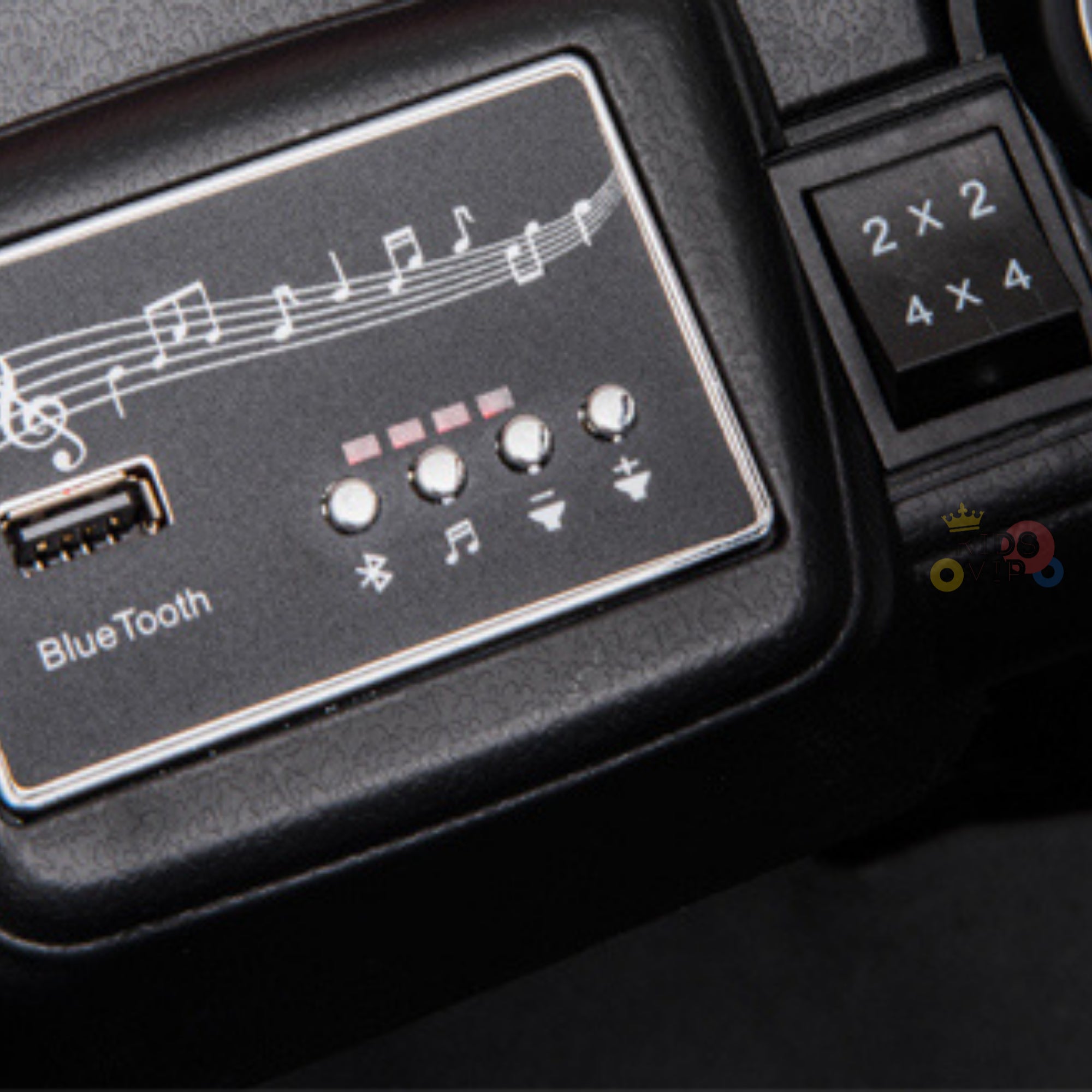 Close-up of a Bluetooth audio panel in the Upgraded 12V Junior Sport Utility Ride On Buggy/UTV 4WD Edition w/Remote Control. It includes a USB port, Bluetooth buttons, track and volume controls with musical notes, and a visible small keypad with numbers 2x2, 4x4 showcasing its upgraded features.