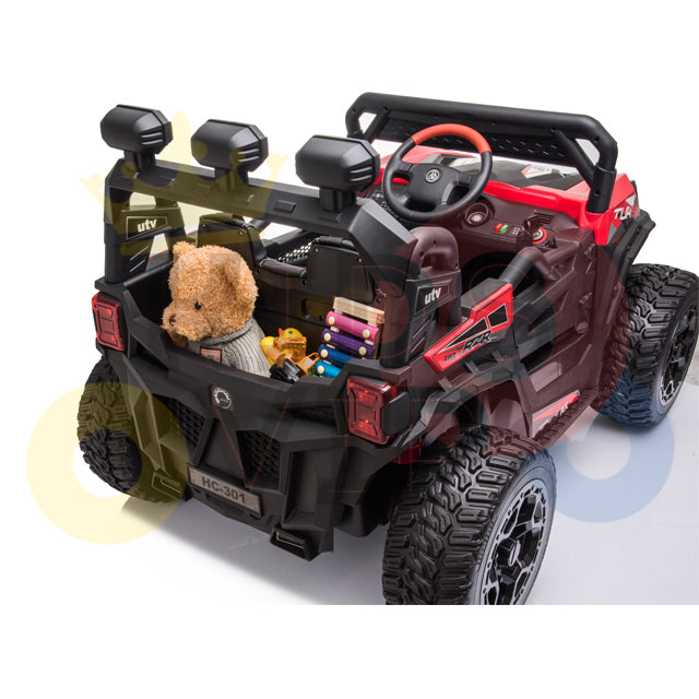 The Upgraded 12V Junior Sport Utility Ride On Buggy/UTV 4WD Edition features a bold red and black off-road look. It includes a red steering wheel and rear cargo area packed with a teddy bear and colorful markers, setting the stage for your childs adventurous playtime.