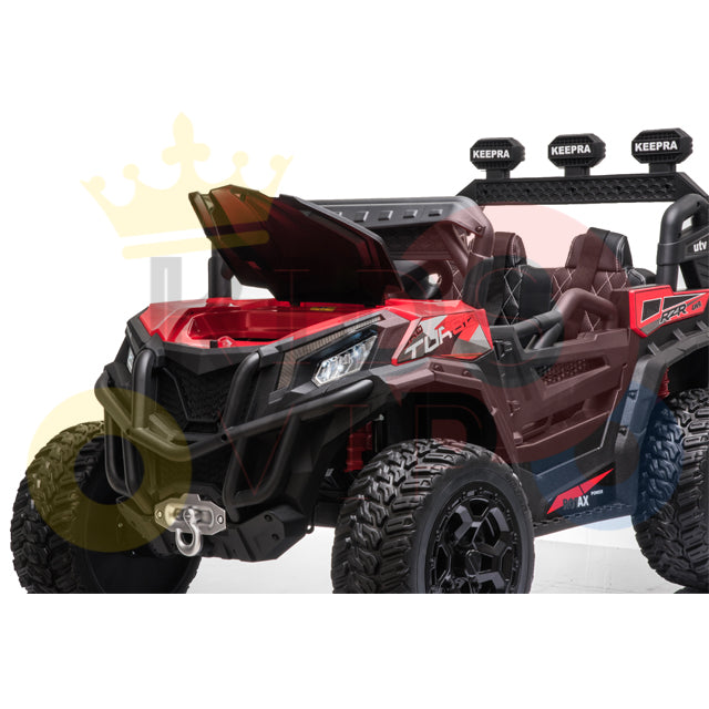 A red and black Upgraded 12V Junior Sport Utility Ride On Buggy/UTV 4WD Edition features large tires, an open hood, a front bumper, and KEEPRA logos on the light bar above the windshield. Its parked at an angle to highlight its impressive side and front.