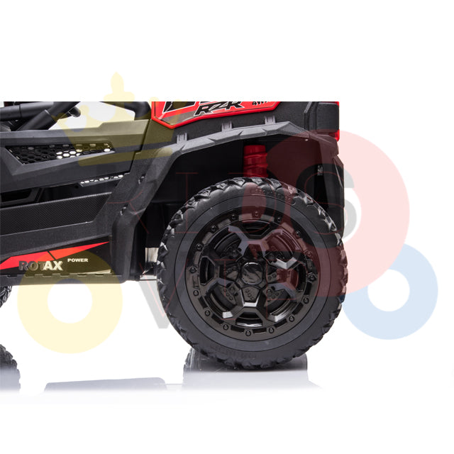 Close-up of a Junior Sport Utility Ride On Buggys side, highlighting its detailed black wheel with ROX and POWER on its body. The white background showcases faint overlapping circles in red, yellow, and blue.
