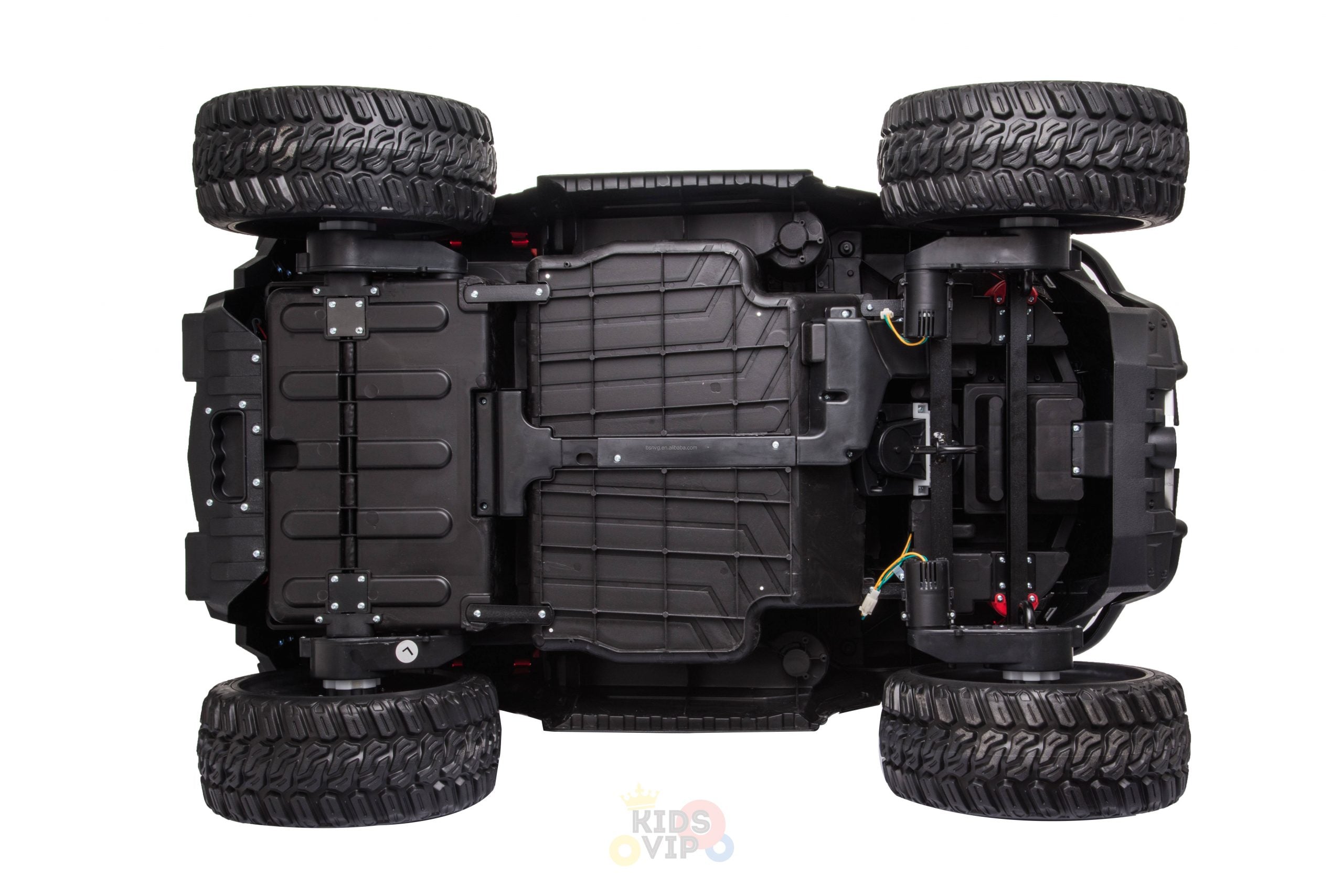 Underside view of the Upgraded 12V Junior Sport Utility Ride On Buggy/UTV 4WD Edition, showcasing thick, textured tires, visible axles, and a detailed undercarriage with wiring and chassis components. The vehicle is positioned horizontally.