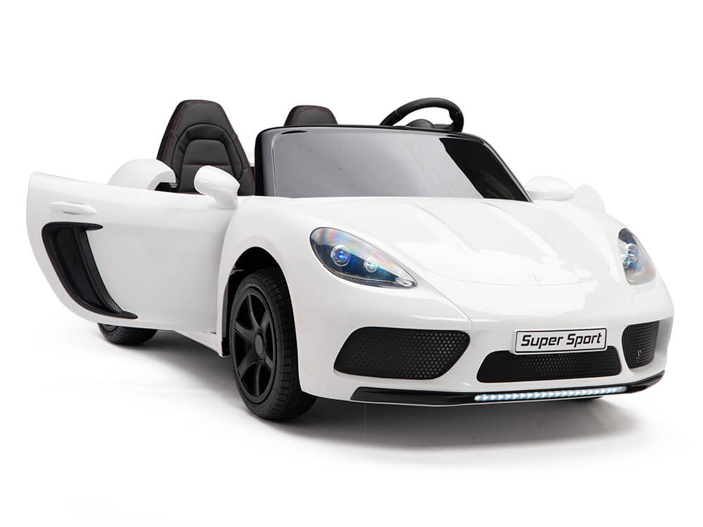 A sleek white ride-on toy sports car with the drivers side door ajar, featuring black accents on rims and interior seats. The front license plate reads XXL Super Ride, perfect for little racers dreaming of speed.