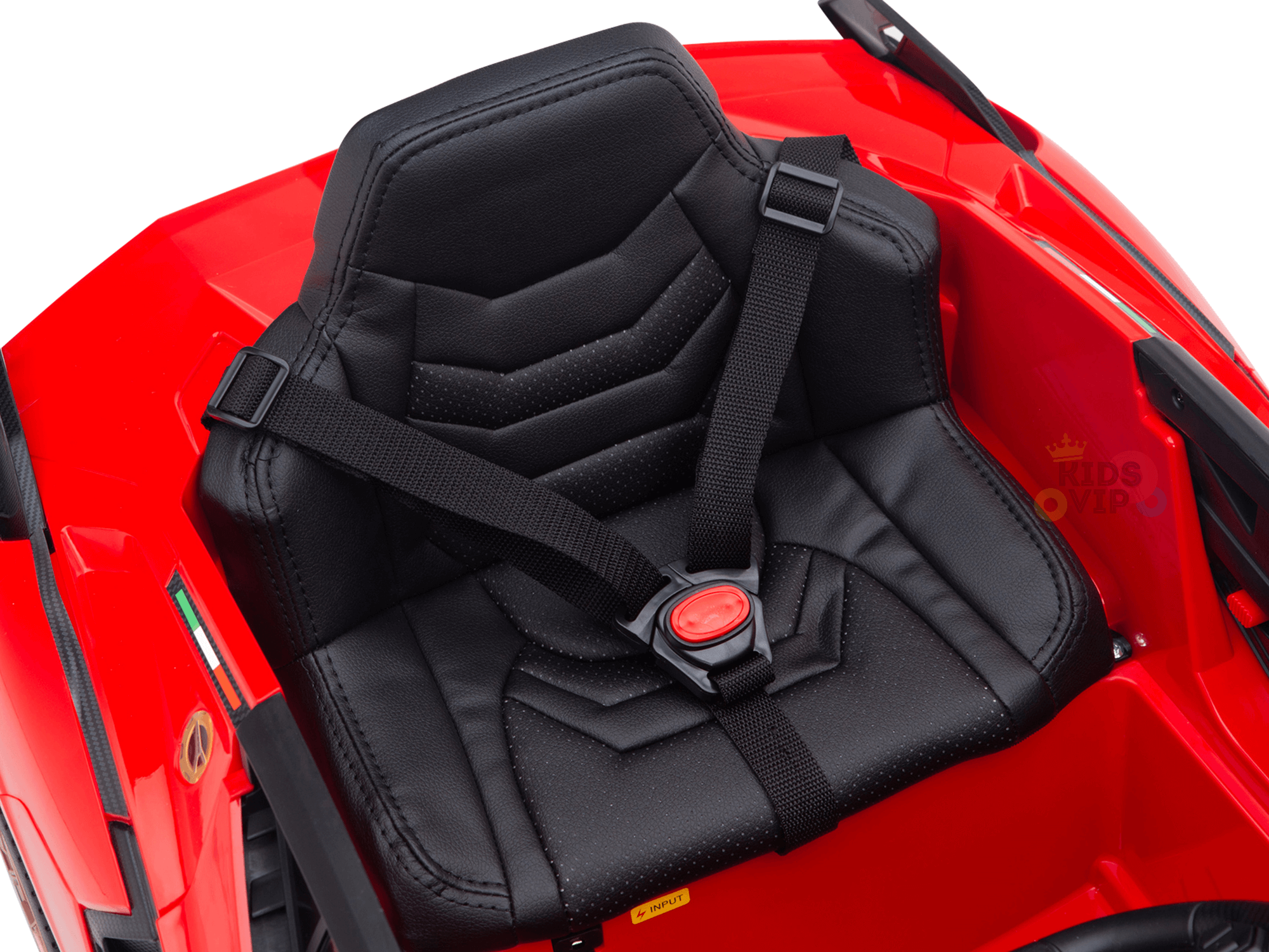 A close-up of a black, padded seat with a five-point harness in the Red Official 12V Sport Edition Lamborghini Sian Kids and Toddlers Ride On Car. The harness is secured with a red center buckle, highlighting the cars glossy finish, sleek style, and Butterfly Doors.